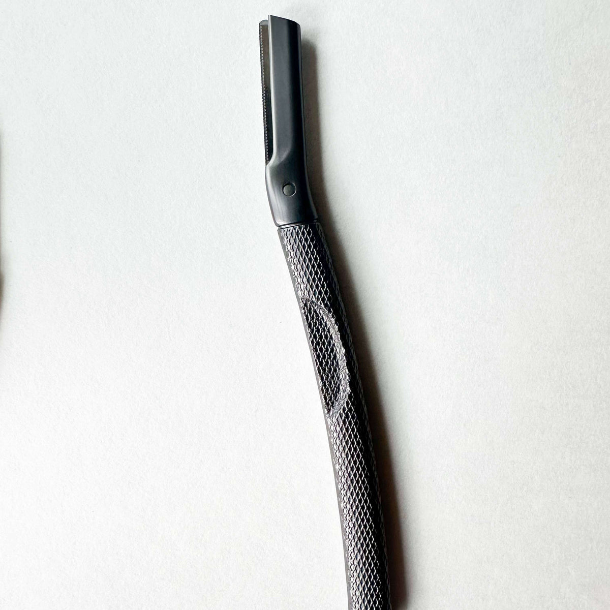 Black and silver razor on a white background