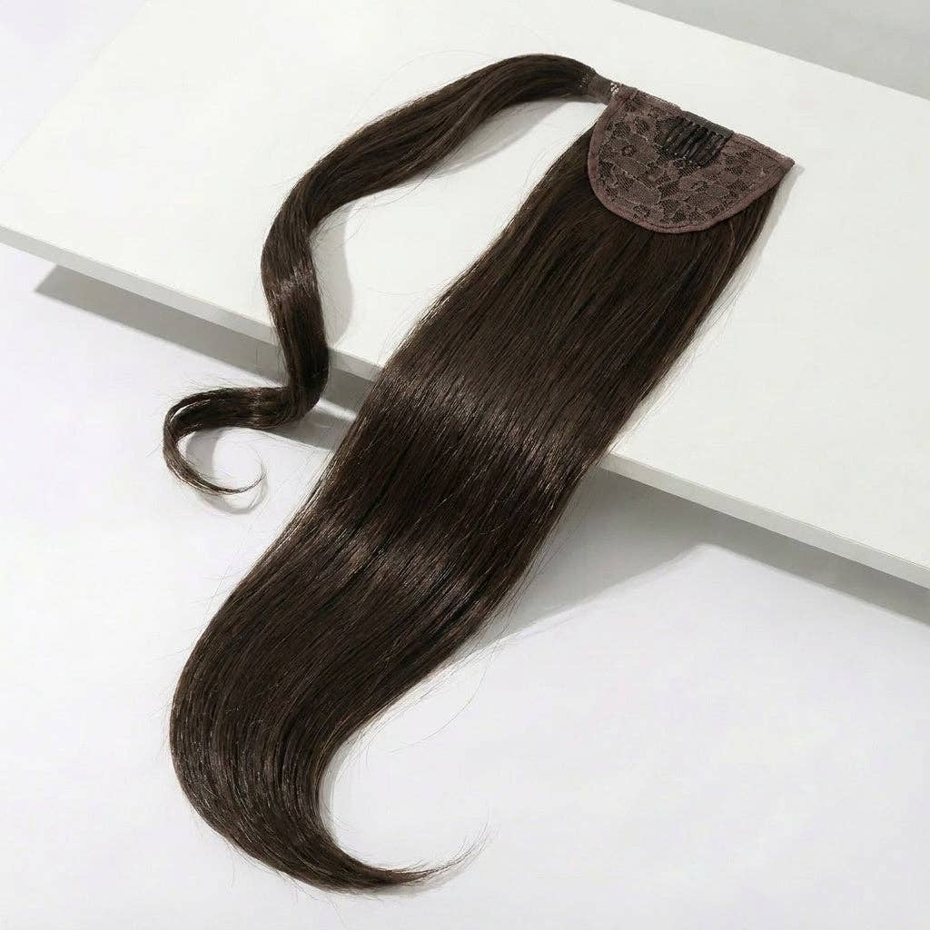 Ponytail Hair Extension - Silky Straight - Medium Brown shown on a white surface, showcasing its sleek design.