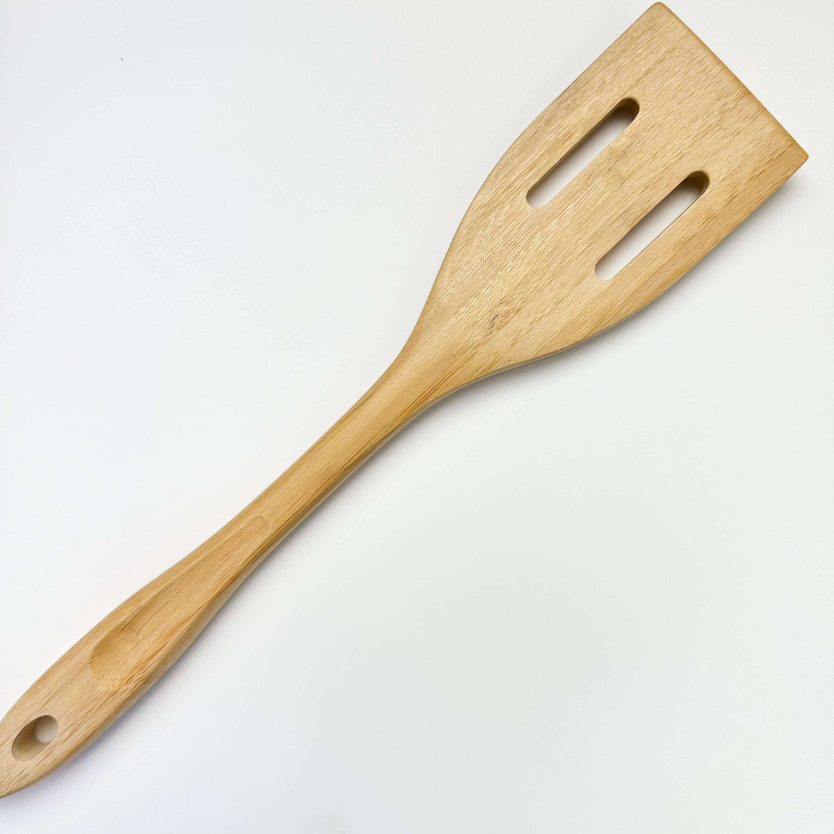 Wooden spatula on a light gray background