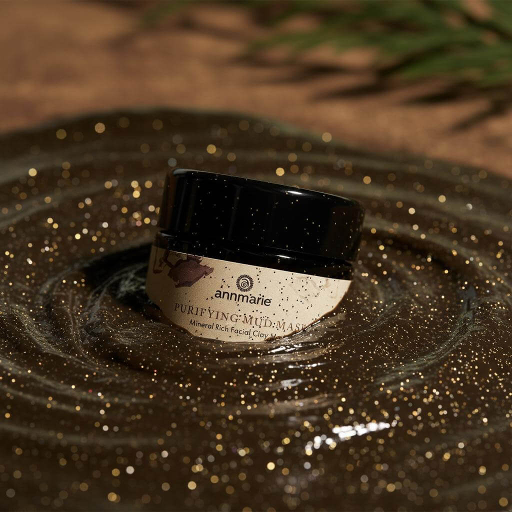 Cosmetic jar labeled 'annmarie' on a textured surface with a blurred natural background