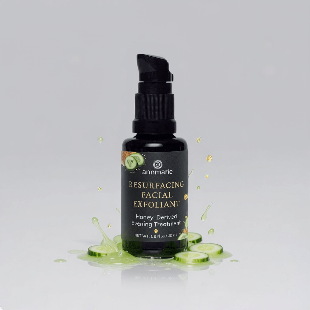 Bottle of 'Resurfacing Facial Exfoliant' with cucumber slices on a gray background