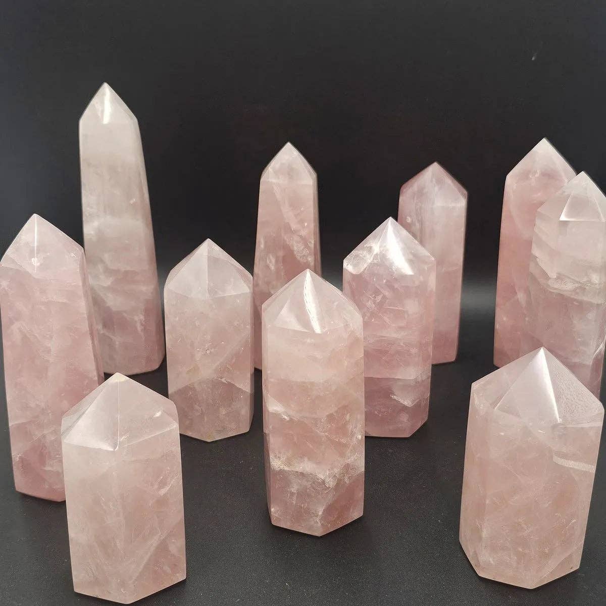 Rose Quartz Crystal Towers displayed, showcasing unique hand carved and polished Madagascar Rose Quartz in various shapes.