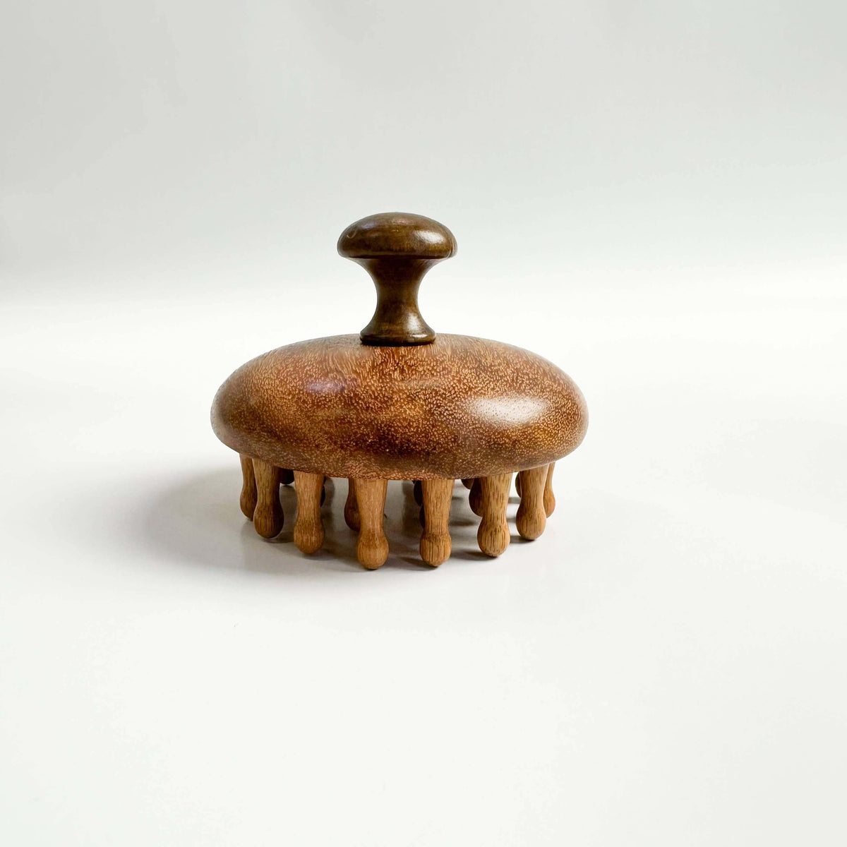 Wooden scrubber with a handle on a white background