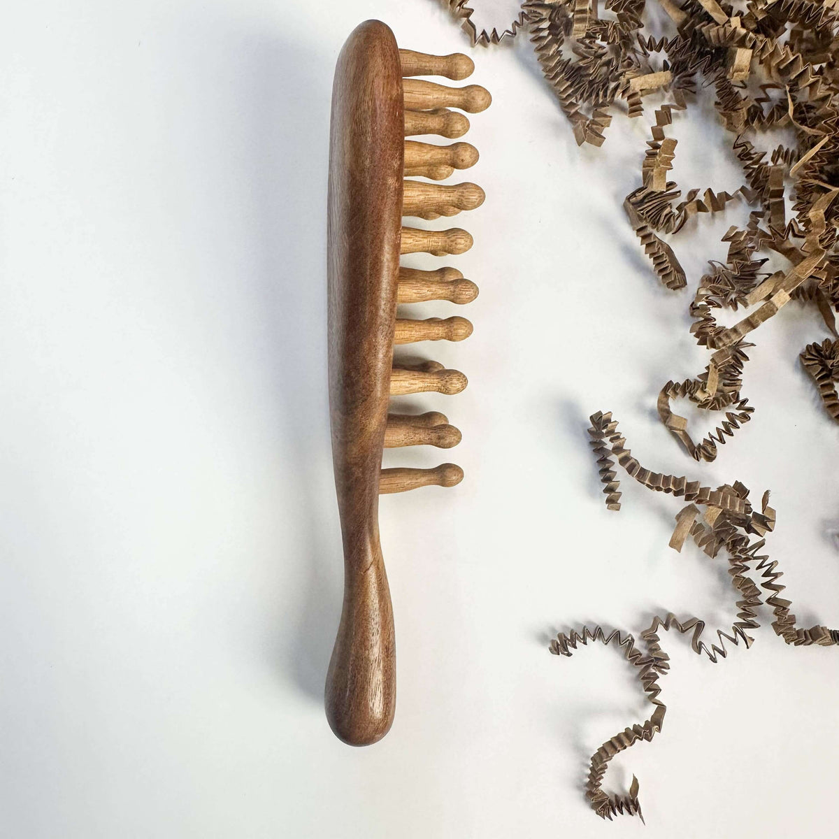 Wooden hairbrush with bristles on a white background