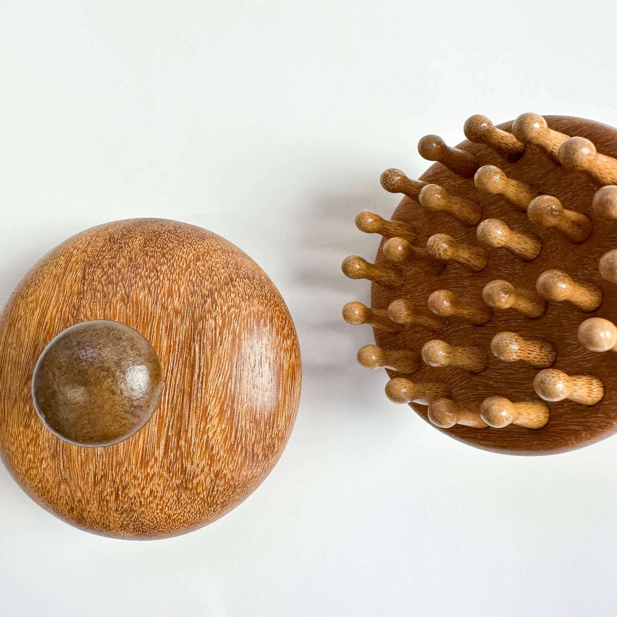 Wooden ball and wooden brush on a white background