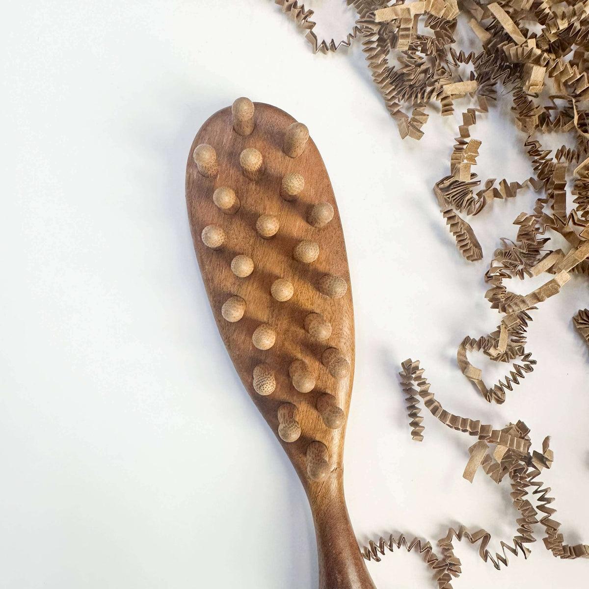 Wooden brush with bristle attachments on a white background