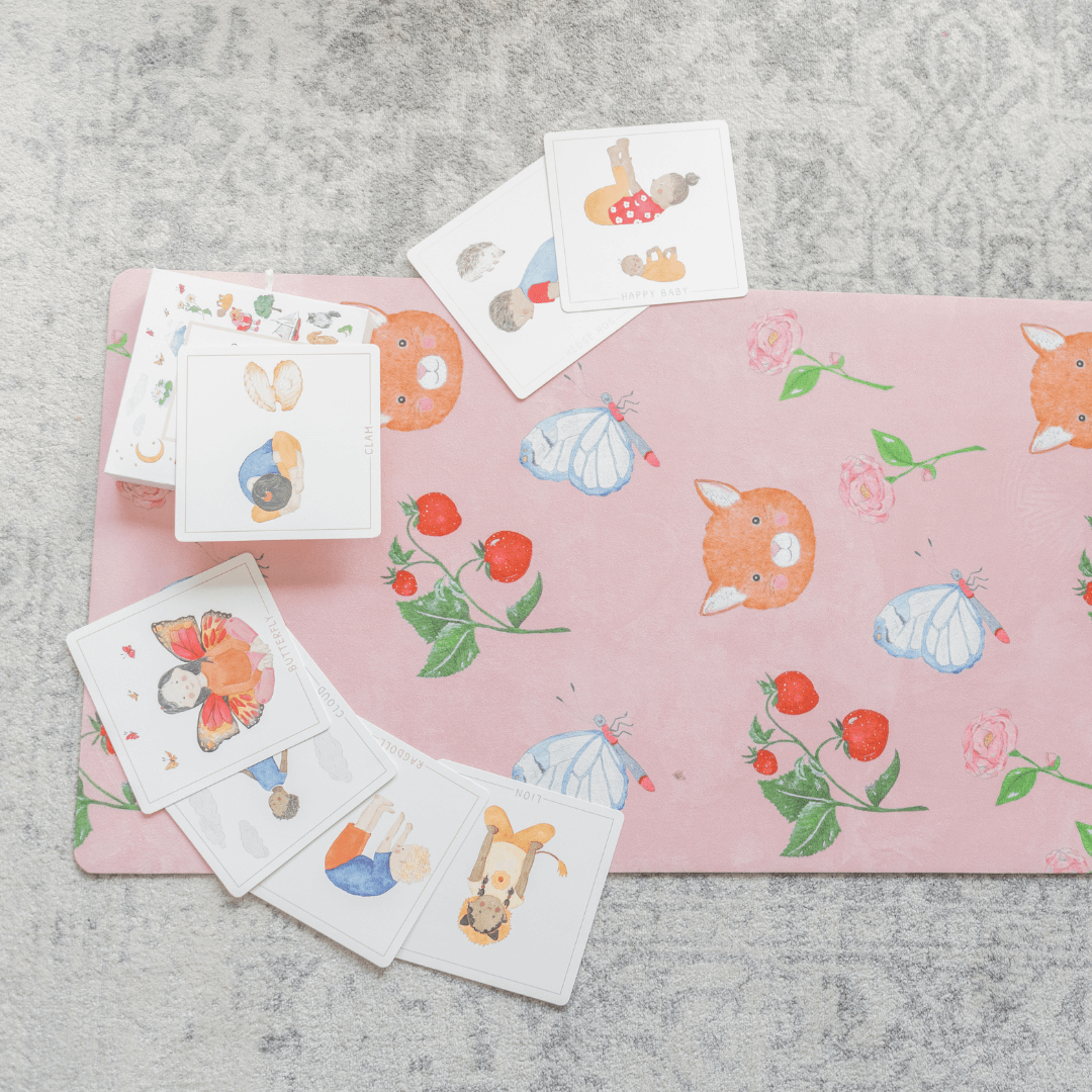 Set of temporary tattoos on a pink mat with cartoon designs on a gray surface
