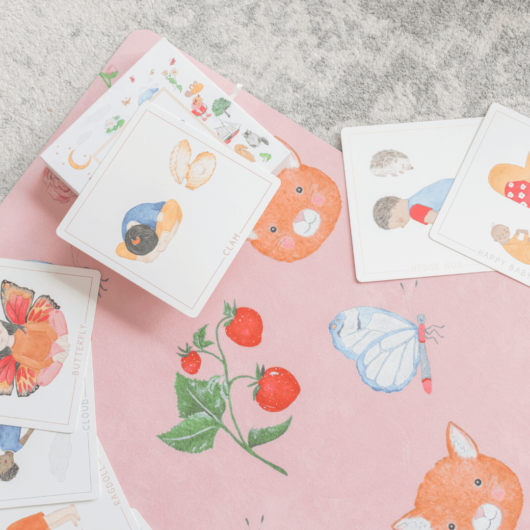 Illustrated cards with animals and nature on a pink surface