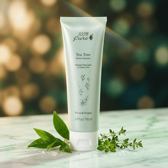 Tube of Tea Tree Detox Cleanser with green leaves on a wooden surface