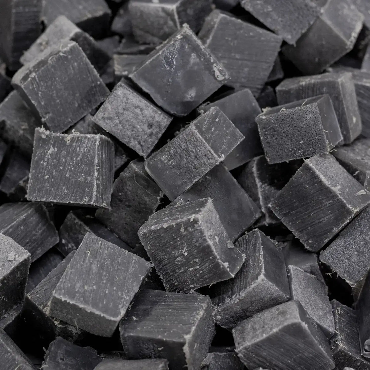 Close-up of dark gray cubes with a rough texture