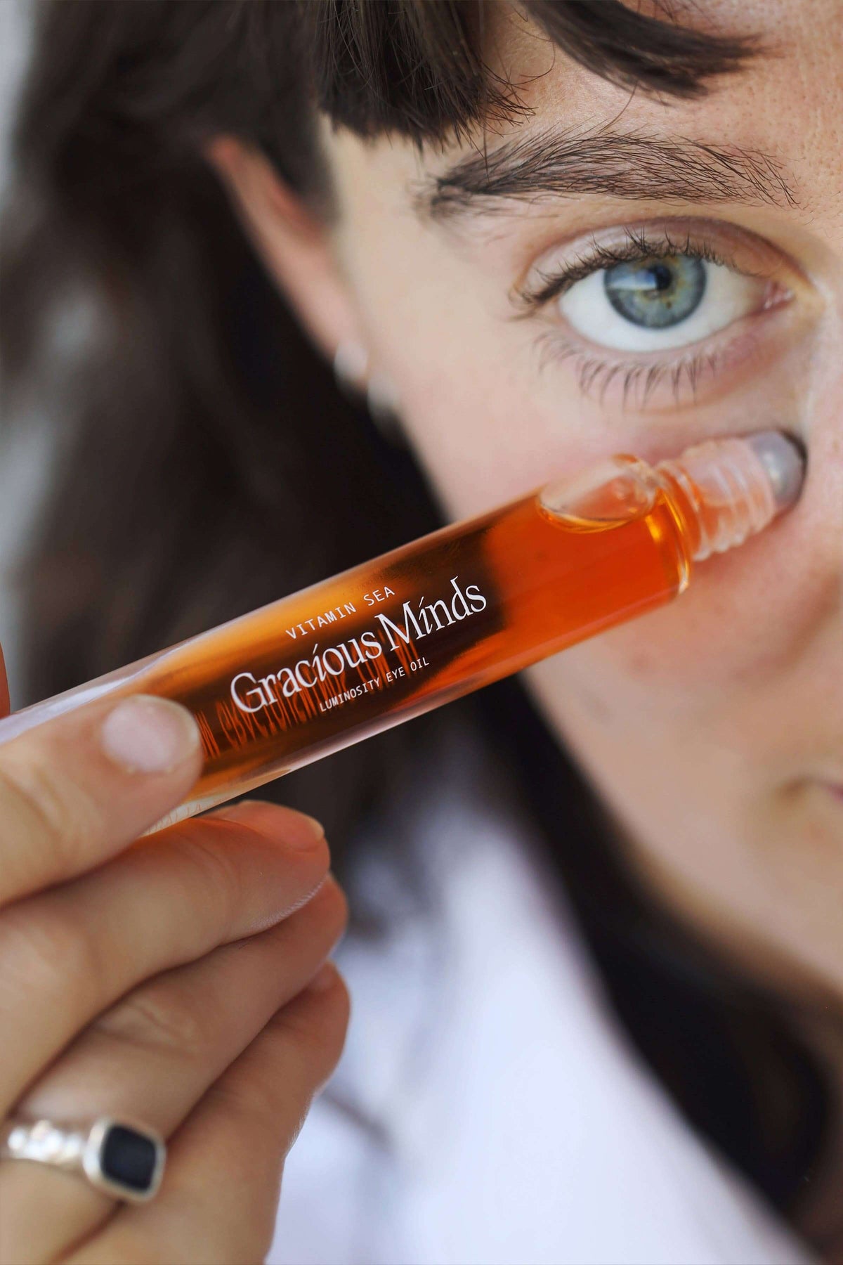 Vitamin C overnight eye oil being applied near the eye area for nighttime skincare routine.