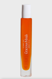 Vitamin C overnight eye oil in a sleek glass bottle with a white cap, showcasing a vibrant orange hue.