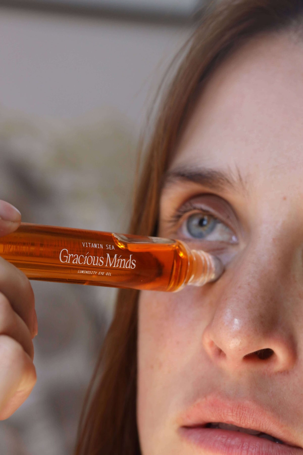Woman applying Vitamin Sea Eye Oil for nighttime skincare, featuring Vitamin C overnight eye oil for brightening.