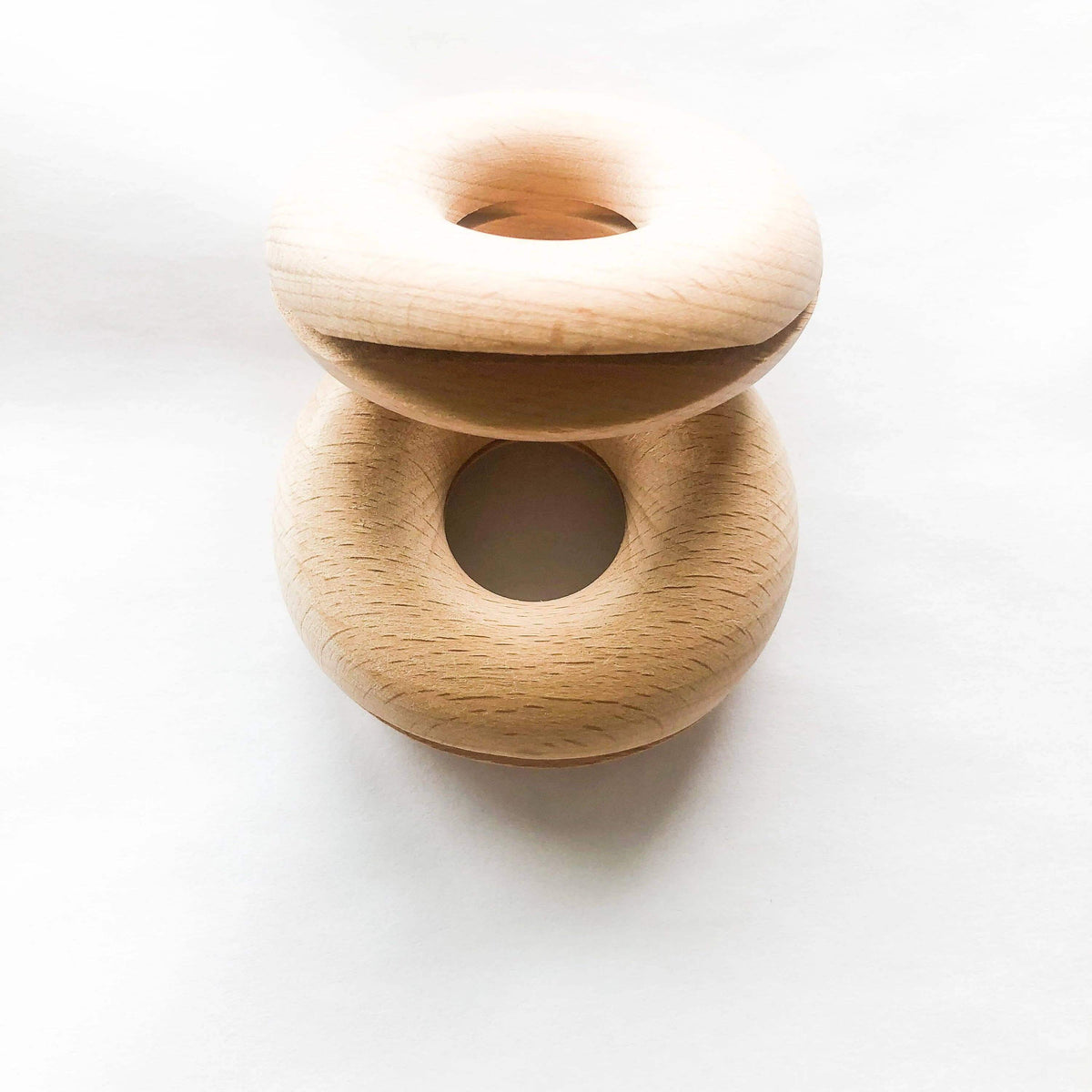 Wooden toy with two interlocking rings on a white background