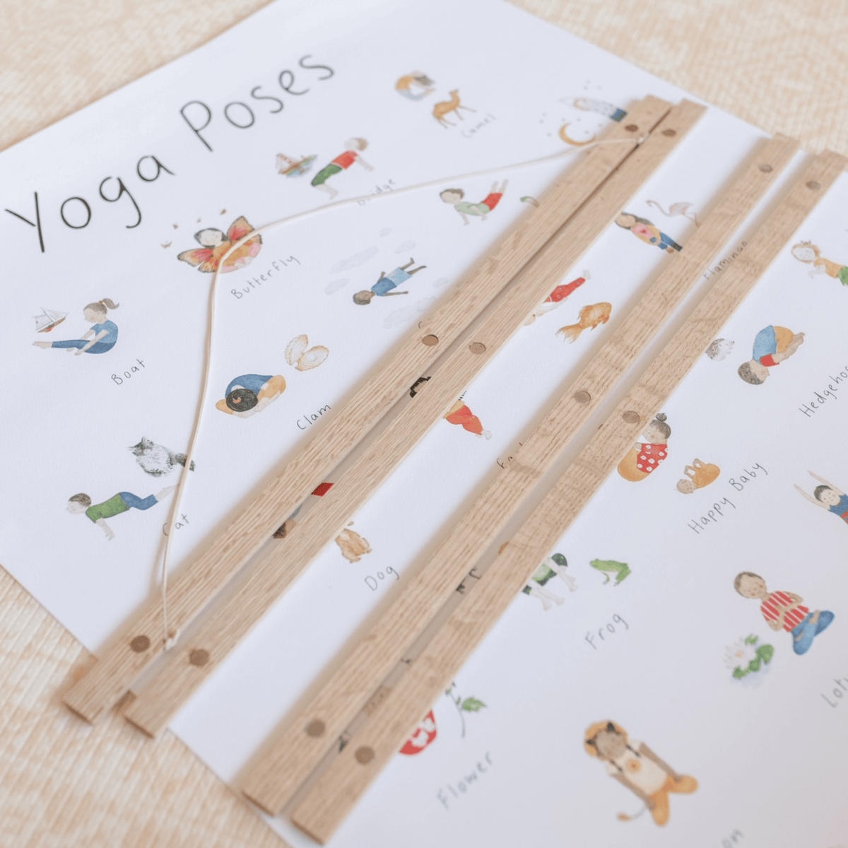 Wooden yoga pose guide with illustrations on a white paper background