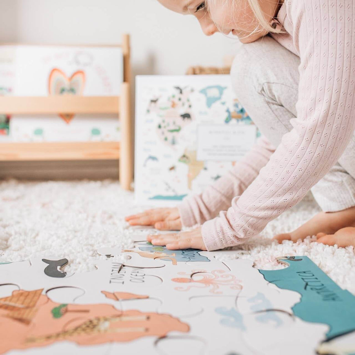 Woman and child playing with a puzzle on a carpeted floor