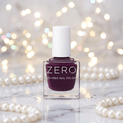Bottle of ZERO nail polish with a blurred background of lights and pearls