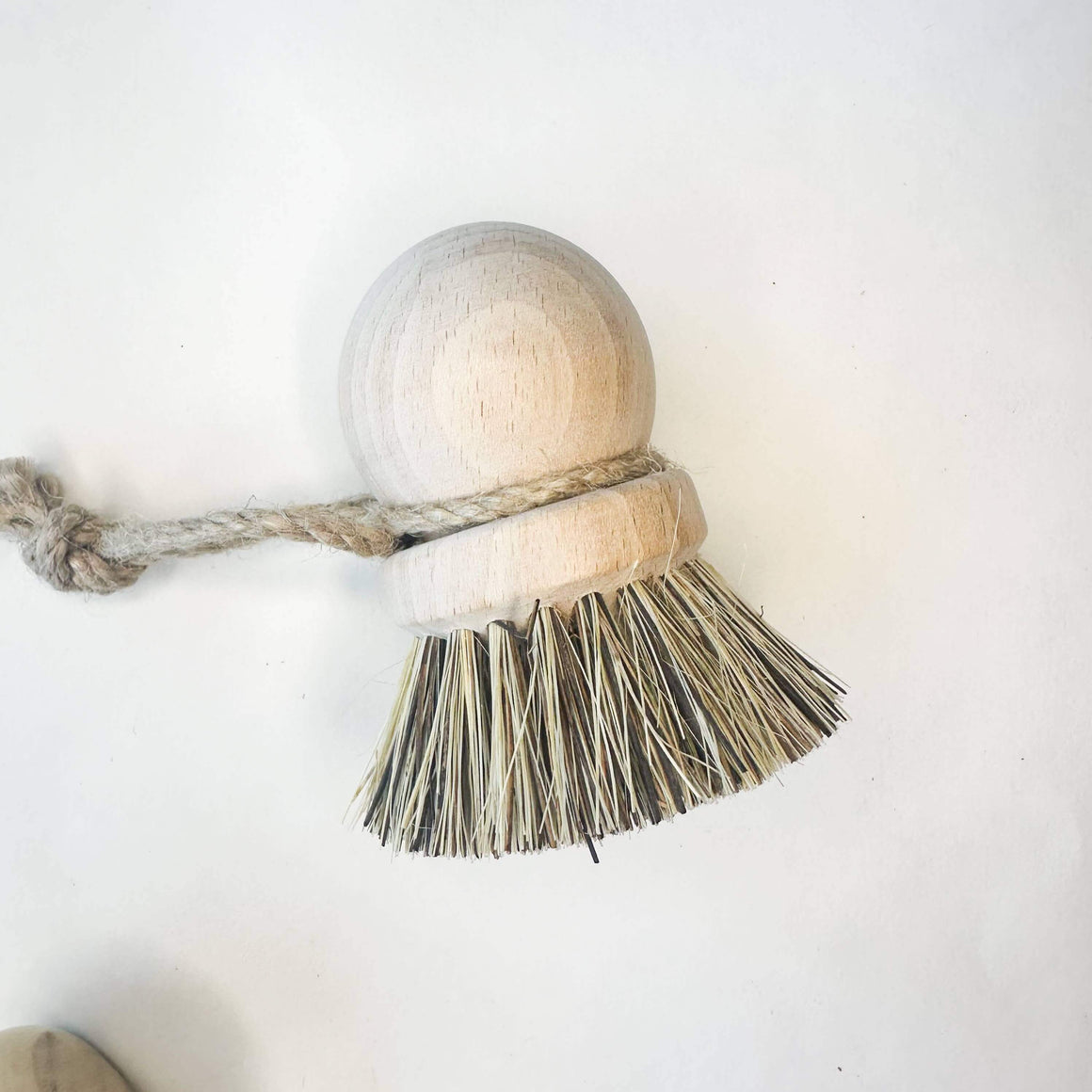 Wooden scrubbing brush with bristles on a white background
