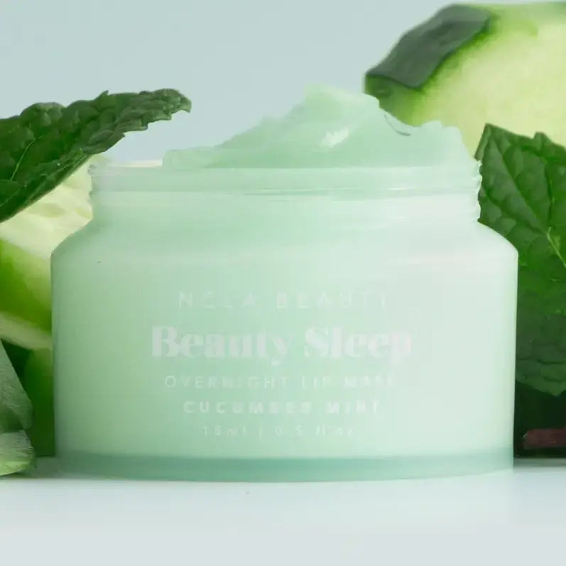 Beauty Sleep Overnight Lip Mask Cucumber Mint in a jar surrounded by fresh cucumber and mint leaves.