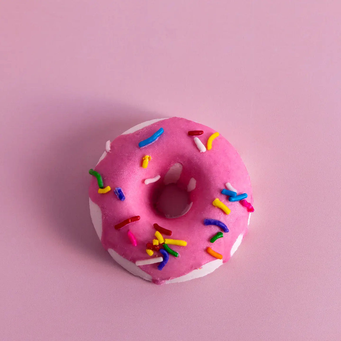 Pink donut-shaped bath bomb from the Birthday Cake Bath Treats set, featuring colorful sprinkles.