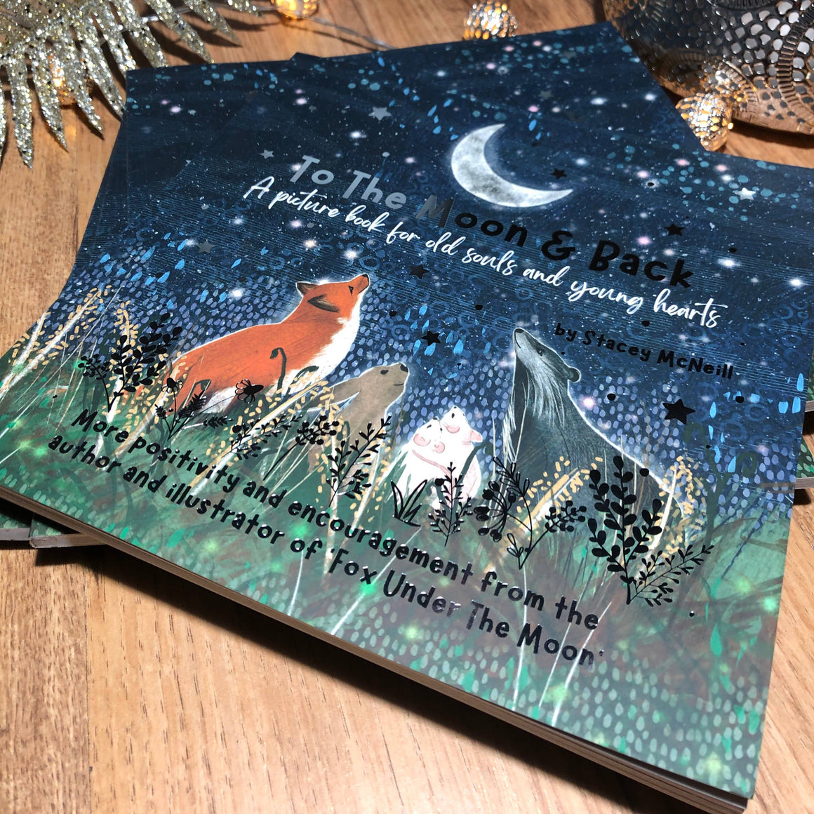 Children's book with fox illustration on a wooden surface