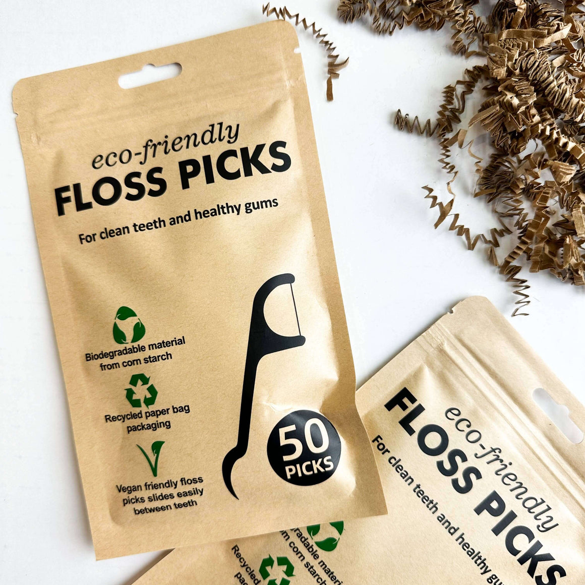 Two packages of eco-friendly floss picks with text on a white background