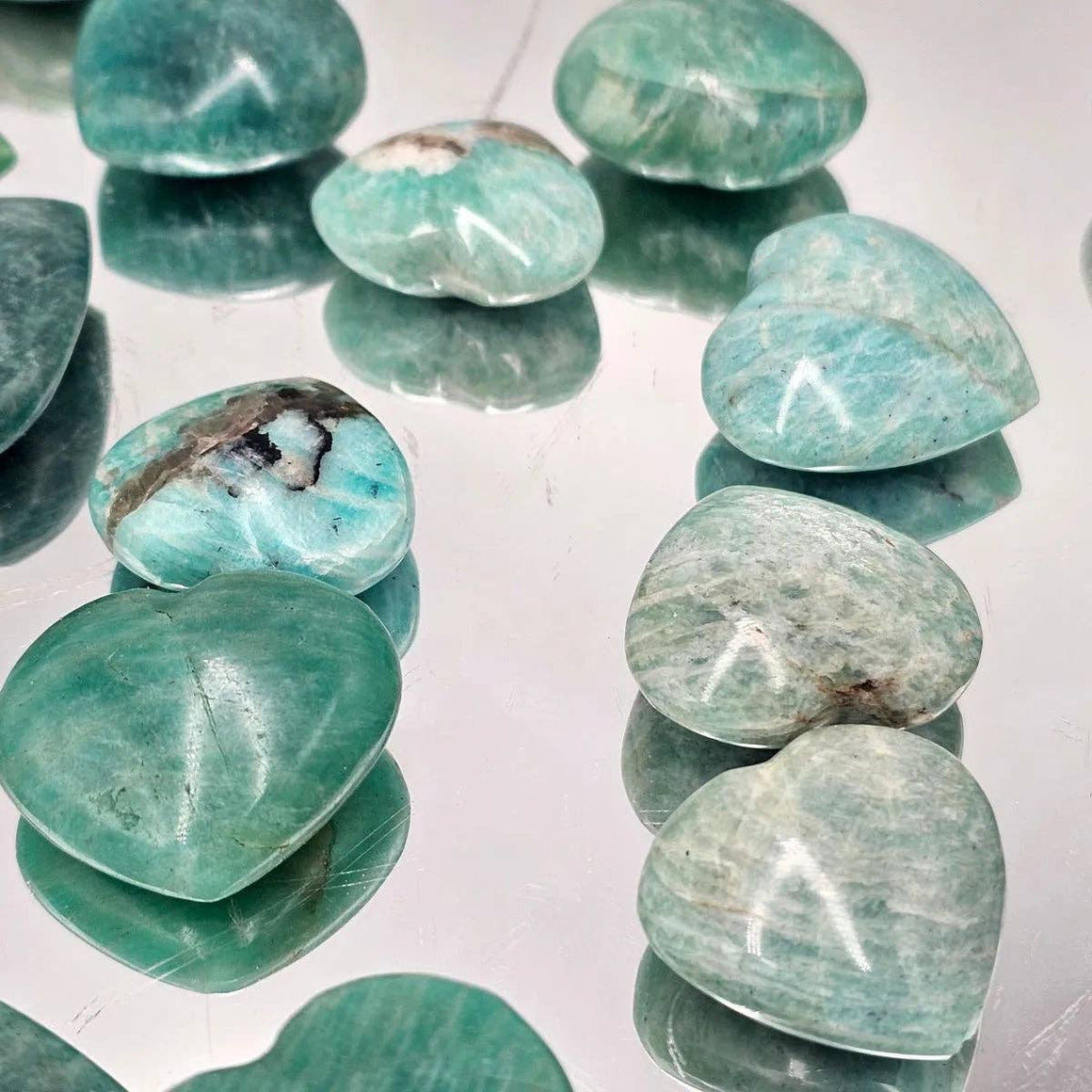 Turquoise stones on a reflective surface