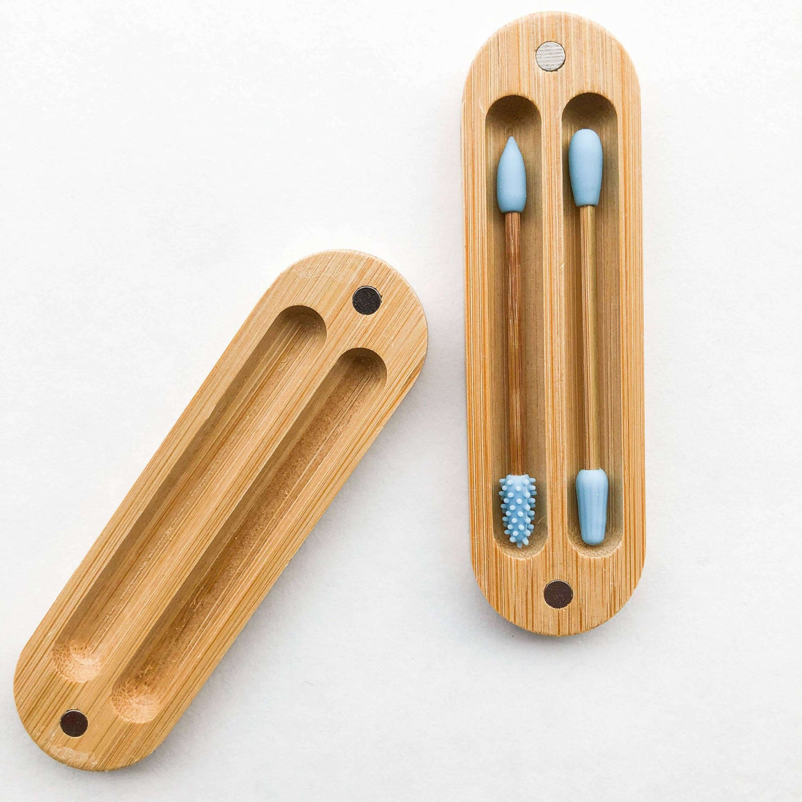 Bamboo toothbrush holder with blue toothbrushes on a white background