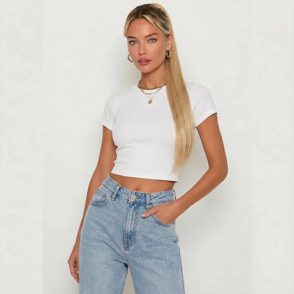 Model wearing a white cropped shirt with high-waisted jeans and long silky straight darkest blonde ponytail hair extension.
